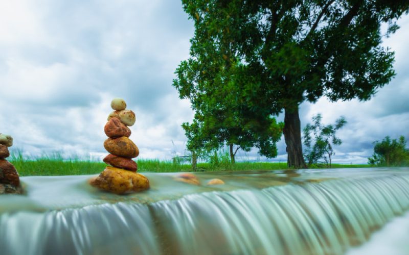 stack-zen-stones-waterfall-clouds-storm-background